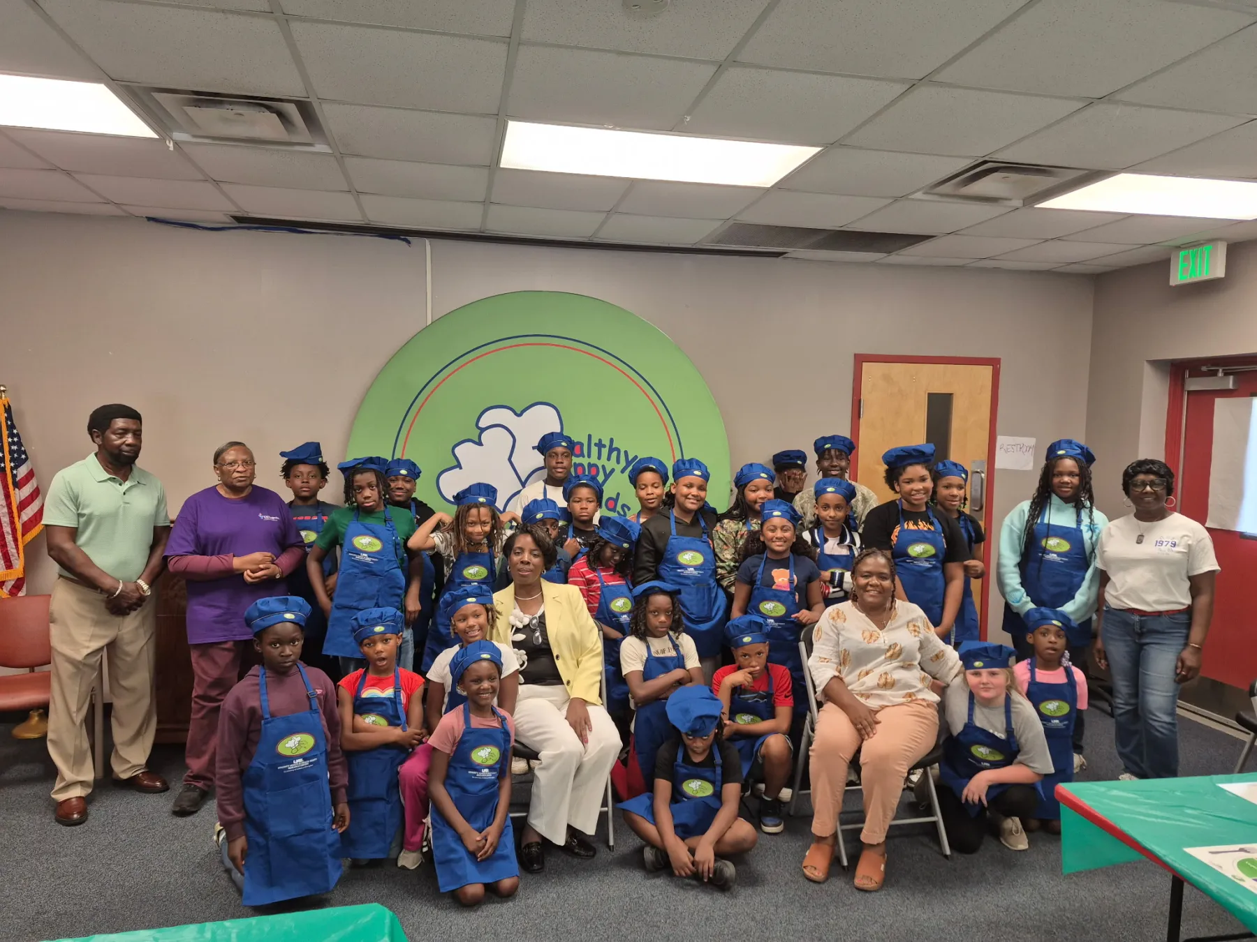 Happy Healthy Kids participants and program leaders gathered in aprons after a session